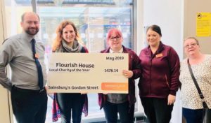 Flourish House receiving a large cheque from Sainsbury’s 
